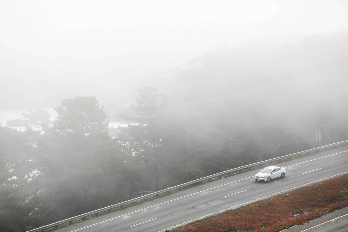 A car drives through the fog on Skyline Drive in San Francisco, California, on Monday, Sept. 16, 2019.