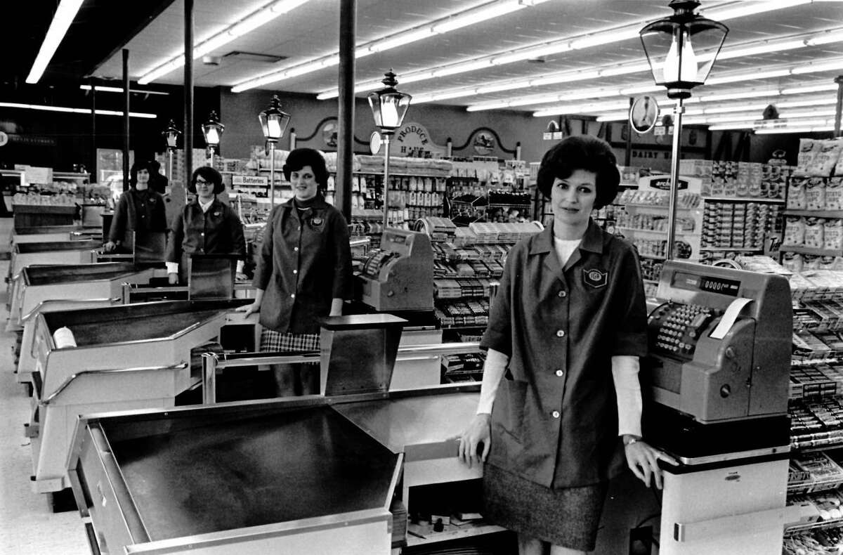 Standing at the check out counters of the new Wentworth IGA at Isabella and Vance roads are, from left, Mrs. Walter McNight, Mrs. Gary Gable, Miss Caroll Storms and Mrs. Ray Koenders. The market includes a delicatessen department and fresh baked good section. December 1970