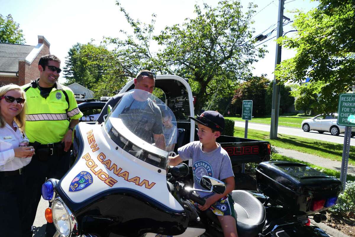 James Golden, 8, looked pretty interested in the motorcycle as he sat in the driver’s seat being shown how to let it rev, but he said, “I like the ambulance best” at the New Canaan EMS open house.