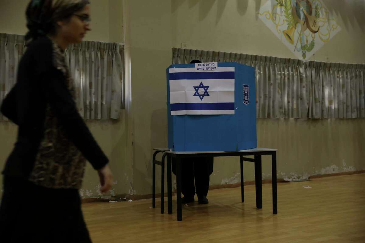 A man votes in Bnei Brak, Israel, Tuesday, Sept. 17, 2019. Israelis began voting Tuesday in an unprecedented repeat election that will decide whether longtime Prime Minister Benjamin Netanyahu stays in power despite a looming indictment on corruption charges. .