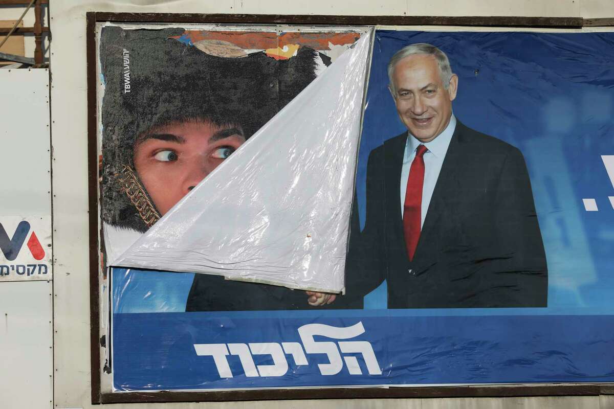 A campaign poster for Israeli Prime Minister Benjamin Netanyahu is seen in Bnei Brak, Israel, Tuesday, Sept. 17, 2019. Israelis began voting Tuesday in an unprecedented repeat election that will decide whether longtime Prime Minister Benjamin Netanyahu stays in power despite a looming indictment on corruption charges. .