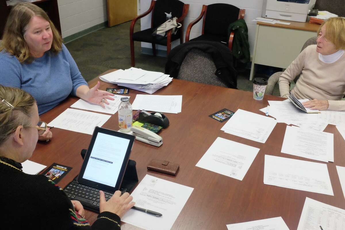 Fair Housing Officer Margaret K. Suib, top left, and Fair Housing Advisory Commissioner Nancy Burke go over a budget request that includes funding for a study of Norwalk housing discrimination on Dec. 11, 2017. The advisory commission is hosting an “Ending Sexual Harrassment in Housing” on Wednesday.