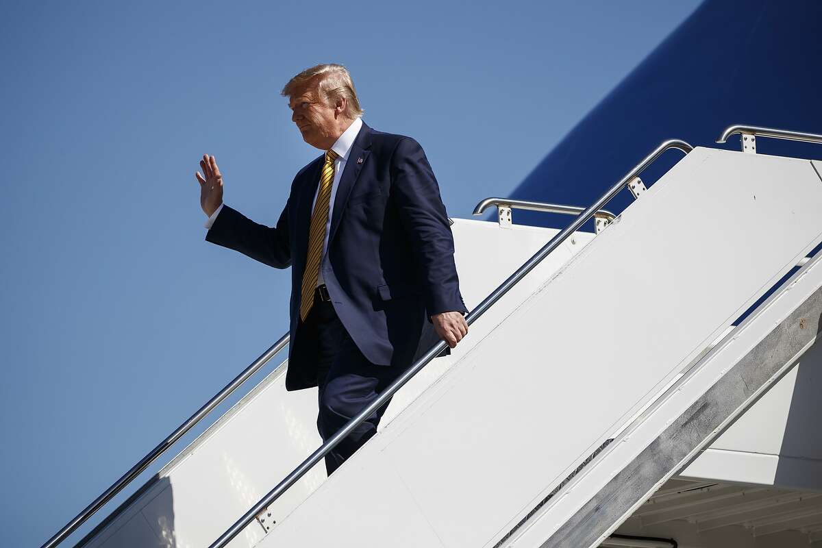 President Donald Trump waves as he arrives at Moffett Federal Airfield to attend a fundraiser in Mountain View, CA on 2019.