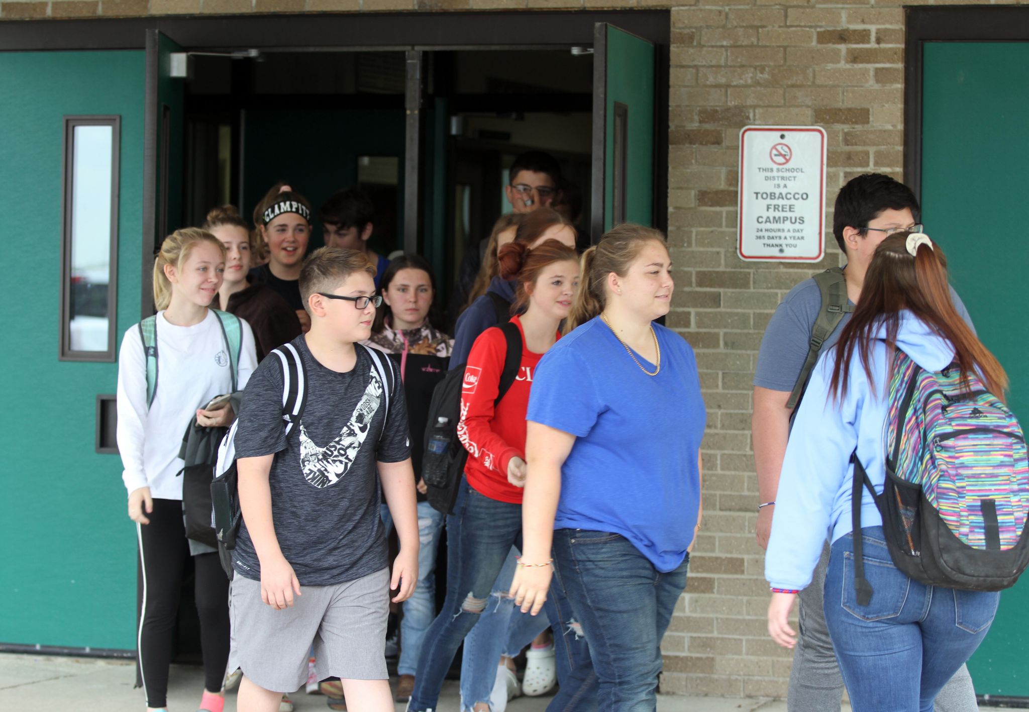 Students walk out in support of former teacher, coach