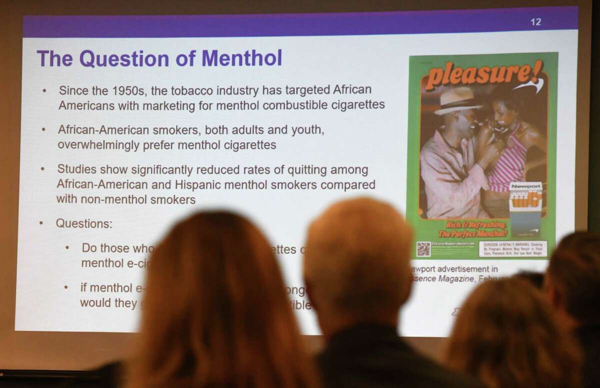 Slide explains the history of menthol flavored tobacco products during a meeting of the state Public Health and Health Planning Council to vote on provisions to ban the sale of flavored e-cigarettes on Tuesday, Sept.17, 2019, at the Empire State Plaza Convention Center in Albany, N.Y. Gov. Andrew Cuomo announced Sunday "an emergency action" to ban the sale of flavored electronic cigarettes statewide. (Will Waldron/Times Union)
