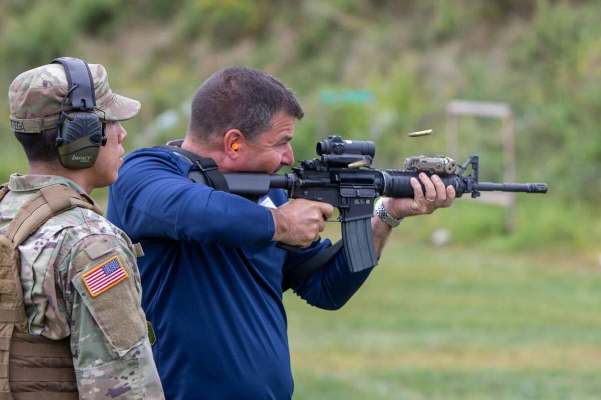 Mathew Zink, the training director for the Bricklayers and Allied Craftworkers Union in Albany, N.Y. fires an M-4 carbine during a "boss lift" at Camp Smith Training Site in Cortlandt Manor, N.Y. on Monday, Sept. 16, 2019 as New York Army National Guard Sgt. Omar Ortega, a member of the 1st Battalion 69th Infantry looks on..Twenty employers from the Albany, N.Y. area and Long Island visited Camp Smith Training Site to get a first hand look at New York Army National Guard training, including using electronic simulators and firing the M-4 and M-9, as part of the Employer Support of the Guard and Reserve program. ( NY Division of Military and Naval Affairs photo by NYG Specialist Michael T. Rehbaum)