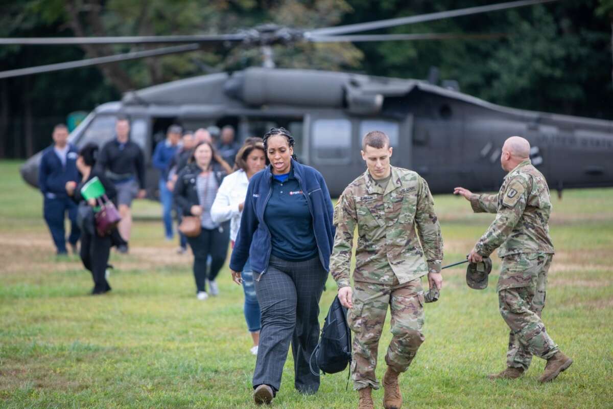 Civilians participating in a boss lift leave a UH-60 helicopter assigned to the New York Army National Guard at Camp Smith Training Site on Monday, Sept. 16, 2019.Twenty employers from the Albany, N.Y. area and Long Island visited Camp Smith Training Site to get a first hand look at New York Army National Guard training as part of the Employer Support of the Guard and Reserve program. ( NY Division of Military and Naval Affairs photo by NYG Specialist Michael T. Rehbaum)