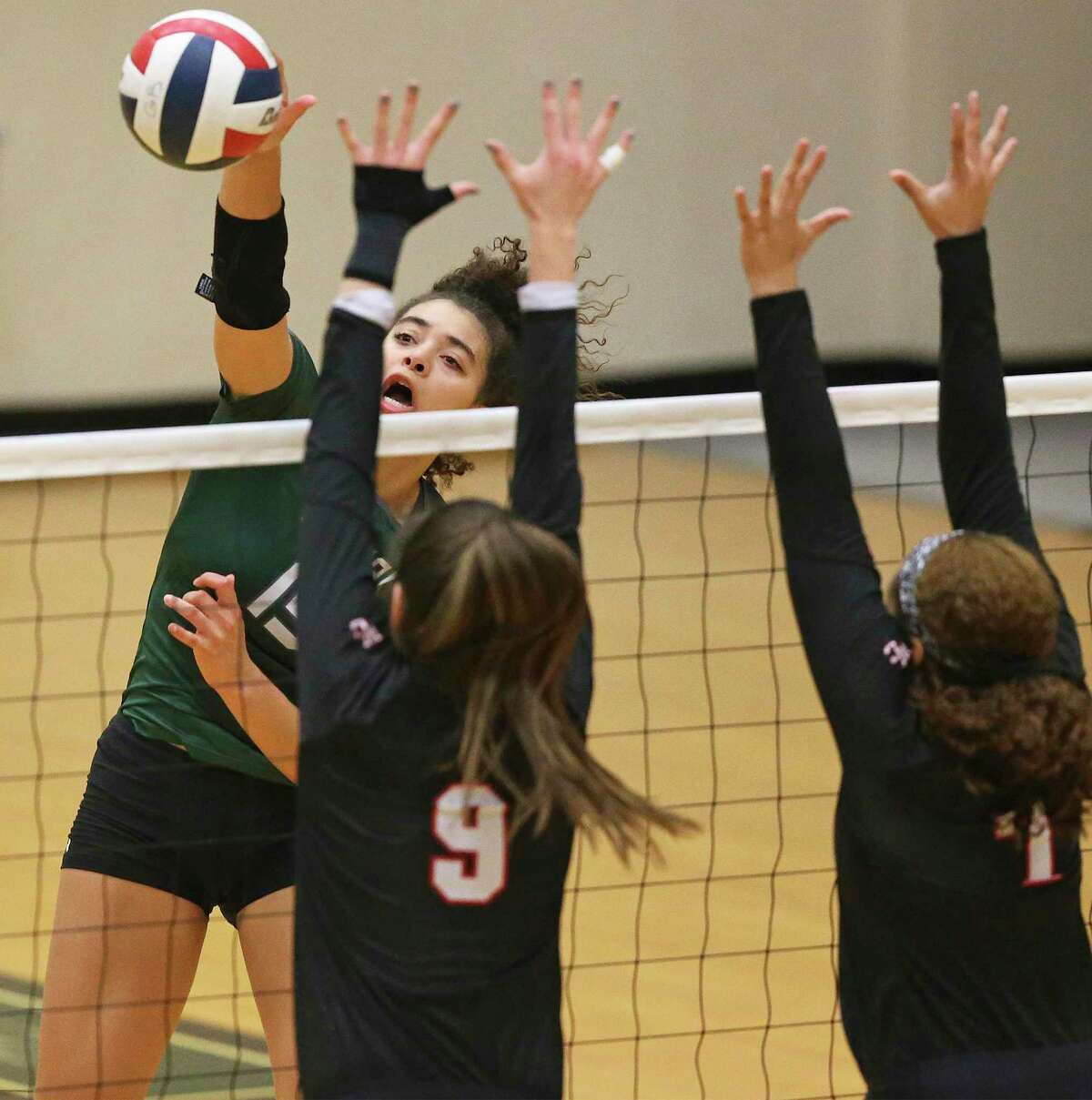 Nyah Anderson blasts another kill for the Rattlers as Reagan beats Churchill 3-0 in volleyball at Littleton Gym on Sept. 17, 2019.