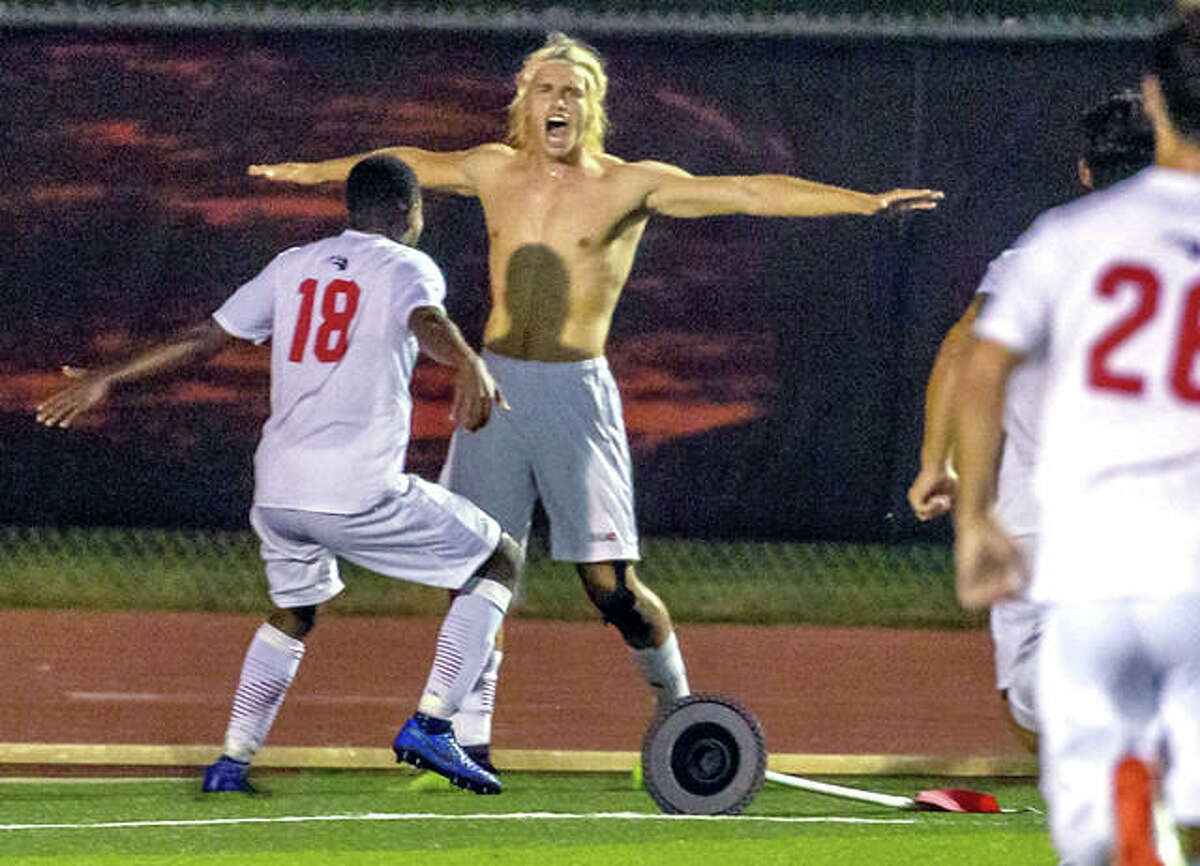 SIUE’s Jorge Gonzalez, after ripping off his jersey, celebrates with teammate Vincent Jackson II (18) Tuesday night after scoring the game-winning overtime goal in the Cougars 2-1 win over Butler at Korte Stadium.