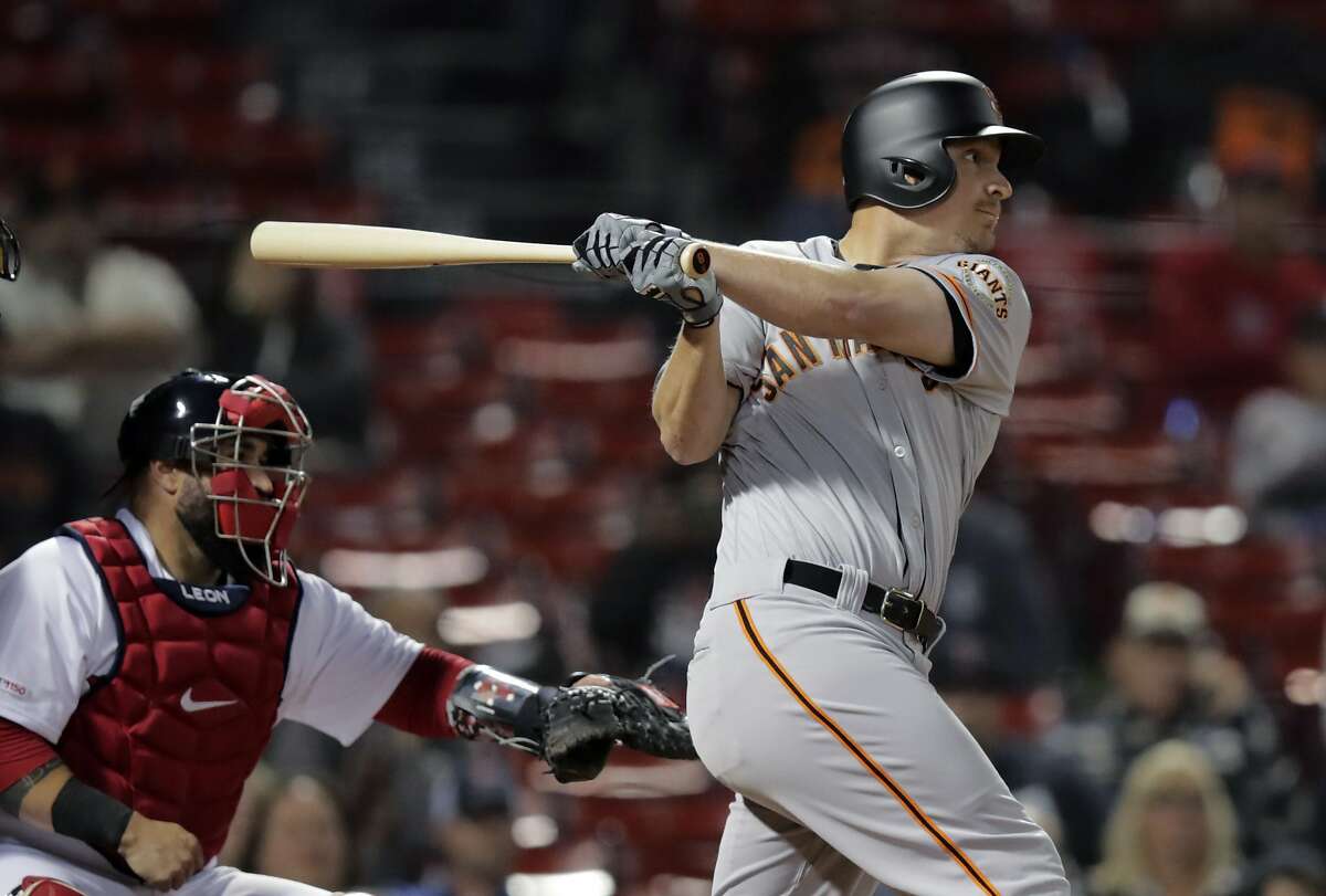San Francisco Giants' Alex Dickerson watches the flight of his RBI sacrifice fly during the 15th inning of the team's baseball game against the Boston Red Sox at Fenway Park in Boston, early Wednesday, Sept. 18, 2019. (AP Photo/Charles Krupa)