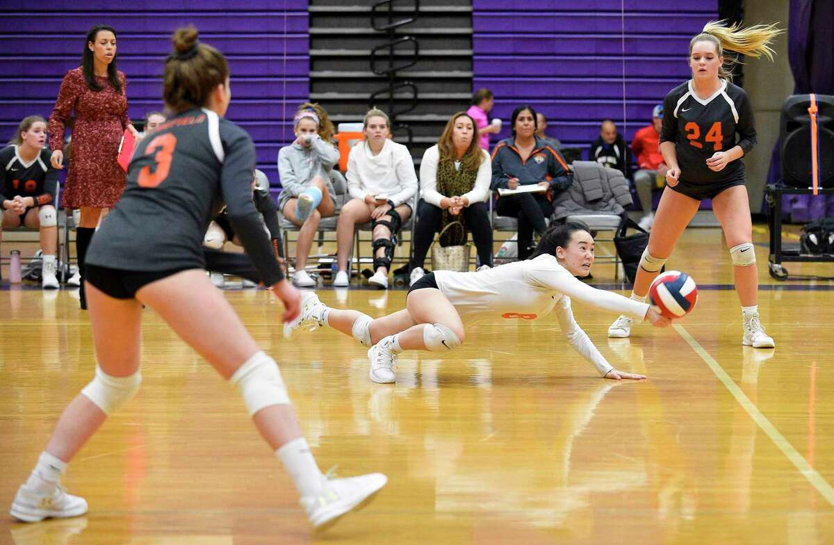 Ridgefield's Joyce Li (8) dives for the return in a varsity girls volleyball match against Westhill on Wednesday, Oct. 24, 2018 in Stamford, Connecticut. Westhill sweep Ridgefield in three sets (25-20, 25-11, 25-22) improving their record to 17-2 over all.
