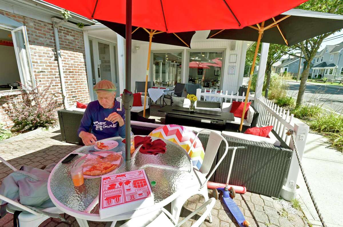 Gus Dudley of Guilford eating lunch on the outdoor patio at Genaros Pizza & Pasta in Branford iocated next to the Short Beach post office. The eatery offers pizza to pastas to seafood to sandwiches.