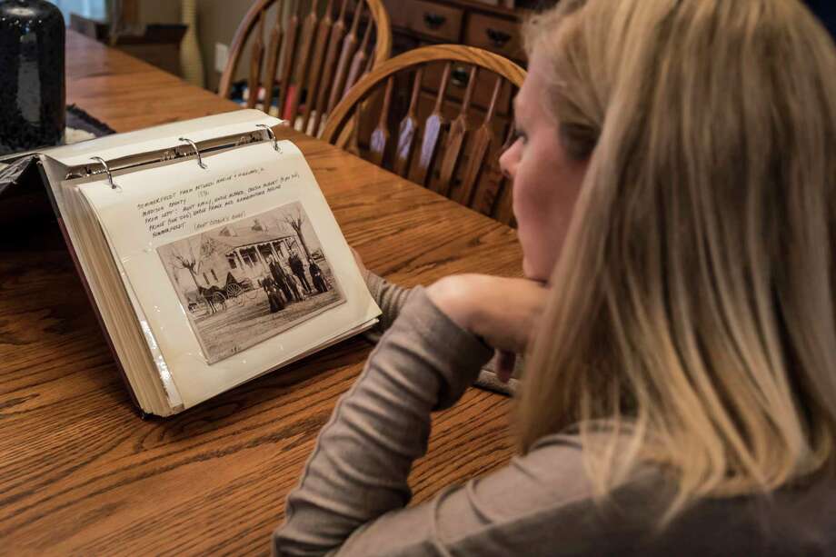 Julie Worthen of Prior Lake, Minn., sits at her dining room table on Sept. 11, looking through the old photo album mailed to her featuring many images of her family dating back to the 1800s. Photo: Nina Robinson