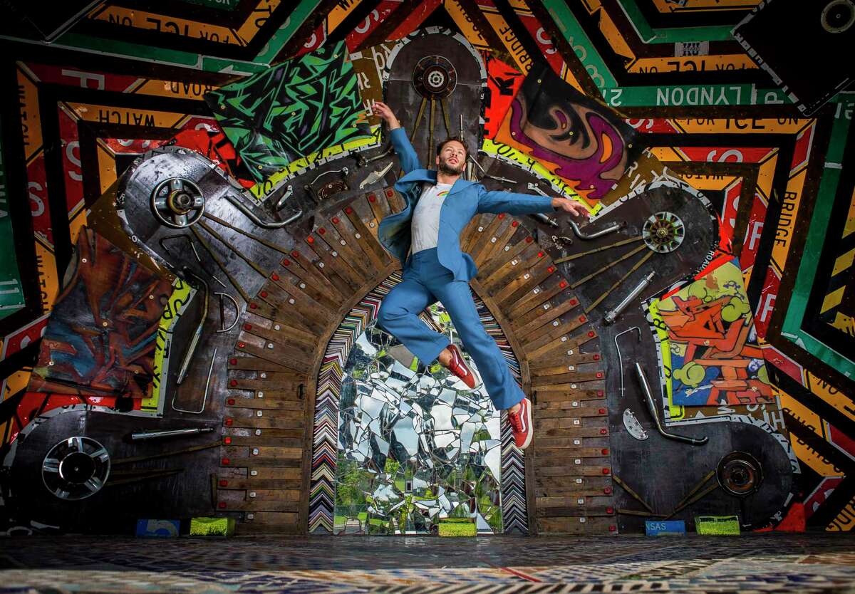 Houston Ballet’s Oliver Halkowich leaps in the amphitheater at Smither Park. The mosaics and mirror tile work there helped inspire the costumes for “Following,” his first solo choreography for the company.