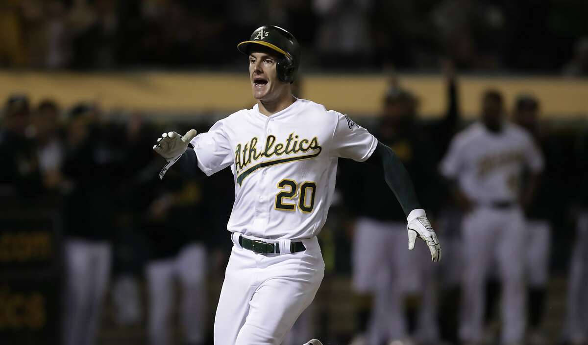 Oakland Athletics' Mark Canha celebrates after scoring against the Kansas City Royals during the seventh inning of a baseball game Tuesday, Sept. 17, 2019, in Oakland, Calif. (AP Photo/Ben Margot)