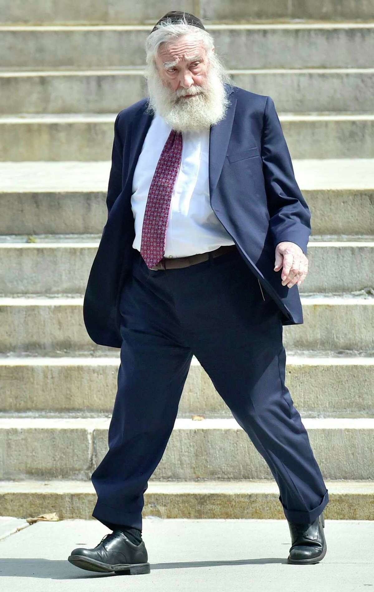 Rabbi Daniel Greer, 77, of New Haven, leaves New Haven Superior Court on Elm Street in New Haven, Conn. Monday, August 14, 2017 after he was arraigned on a criminal charge of second-degree sexual assault and risk of injury to a minor. Greer did not enter a plea. The alleged victim in the criminal charge is Eliyahu Mirlis, of New Jersey, who was awarded $15 million in in his civil lawsuit against Greer in May of 2016. Greer was a dean of the Yeshiva of New Haven/the Gan School, where the alleged victim was a high school student. Greer was accused in May 2016 of repeatedly sexually assaulting Mirlis, of New Jersey, over several years in the early- to mid-2000s. Mirlis attended the school from 2001 to 2005. Greer has denied the allegations.