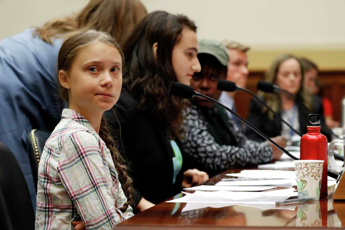 Youth climate change activist Greta Thunberg, left, prepares to speak at a House Foreign Affairs Committee subcommittee hearing on climate change Wednesday, Sept. 18, 2019, on Capitol Hill in Washington. (AP Photo/Jacquelyn Martin)