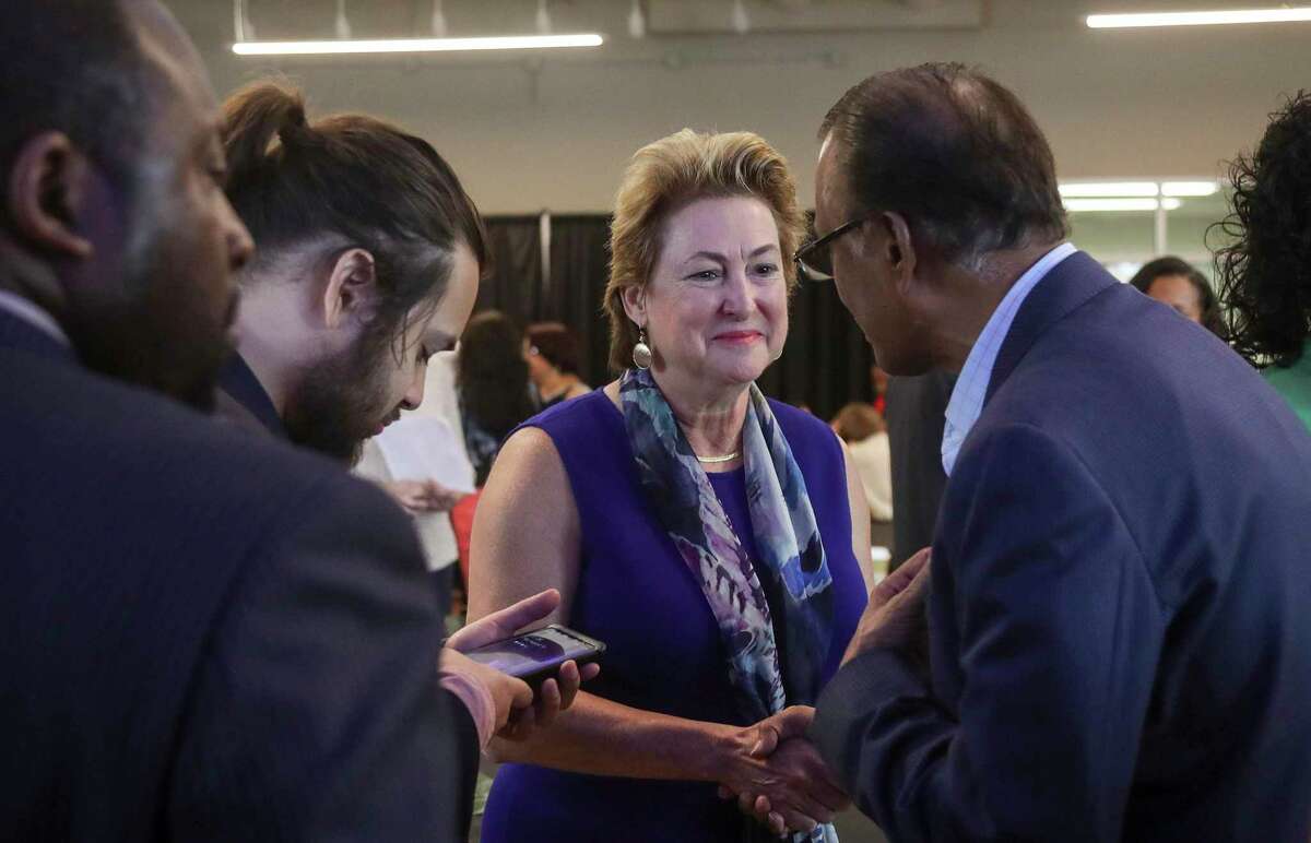 Harris County District Attorney Kim Ogg greets Nishan Khan after a community meeting on Saturday, Aug. 10, 2019, in Houston.