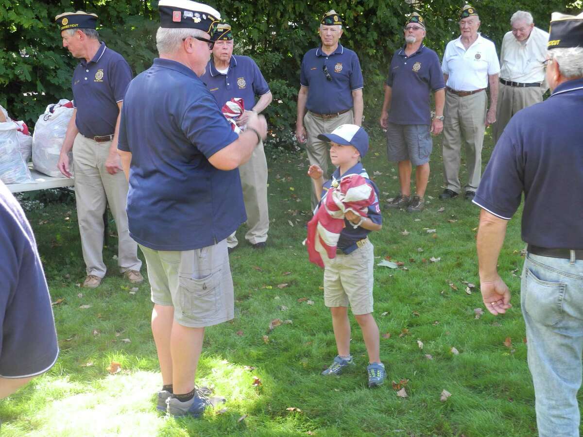 Wilton cub scouts participated in the American Legion Flag Retirement Ceremony last year. Children interested in joining cub scouts may attend an open house with their families on Oct. 17.