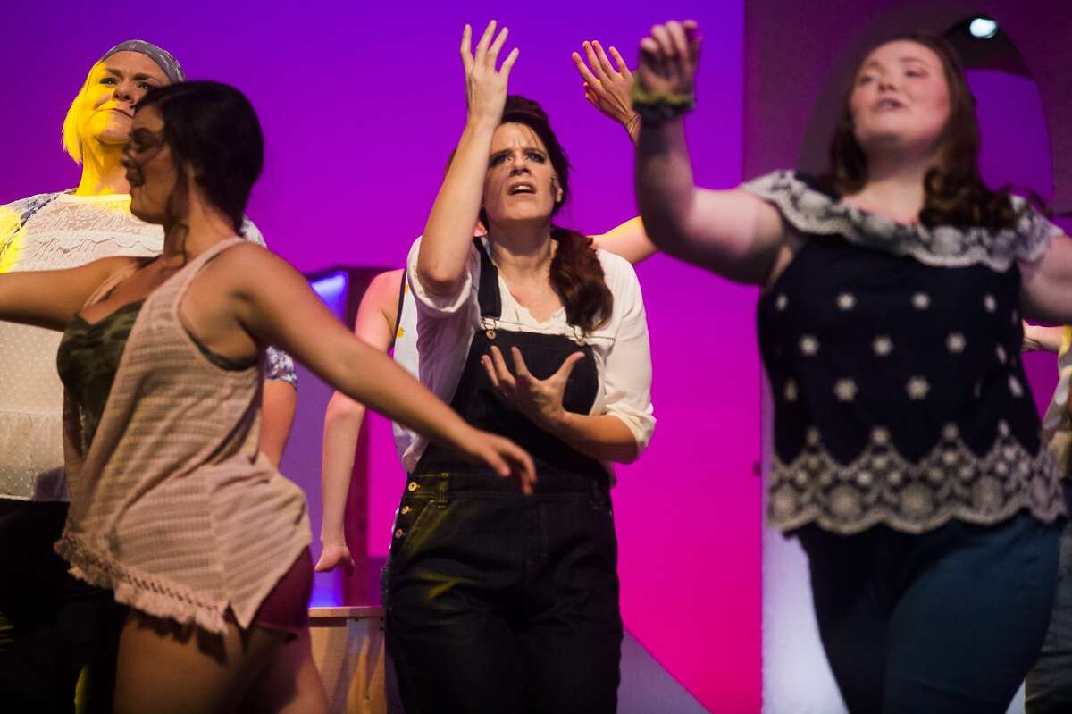 Holly Booth in the role of Donna Sheridan, center, acts out a scene during a dress rehearsal for Great Lakes Bay Regional Alliance's production of "Mamma Mia!" Monday, Sept. 16, 2019 at the Midland Center for the Arts. (Katy Kildee/kkildee@mdn.net)
