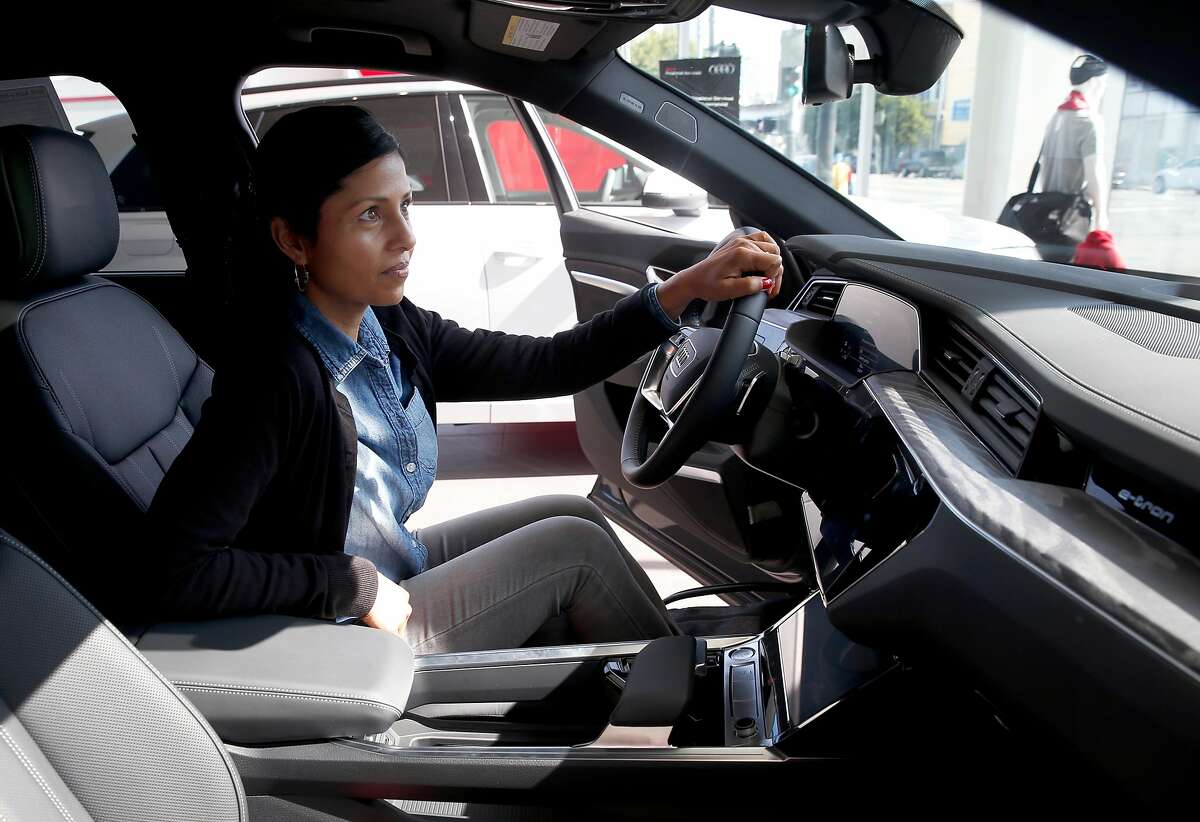 Shantal De Silva sits behind the wheel of an Audi e-tron electric SUV at the Audi dealership in San Francisco, Calif. on Saturday, July 6, 2019. Assemblyman Phil Ting, D-San Francisco, is proposing legislation that would increase the typical rebate for an electric car to as high as $7,500.