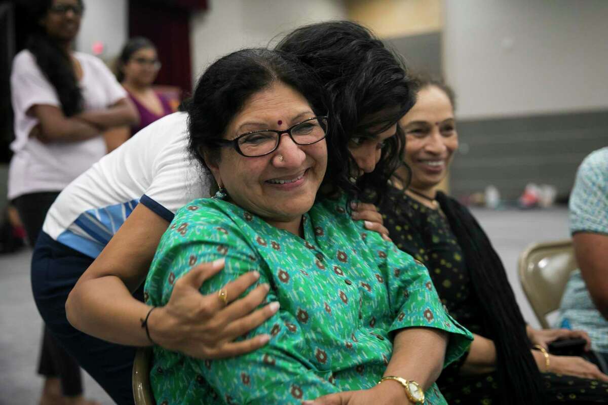 Classical Indian dance teacher Rathna Kumar is comforted by artistic director and co-producer Henna Patel during dance practice at Gujarati Samaj recently in Houston. Several forms of classical Indian dance groups will join other styles of dance as part of a bigger performance entitled “Woven” in honor of Indian Prime Minister Narendra Modi’s visit to Houston Sept. 22.
