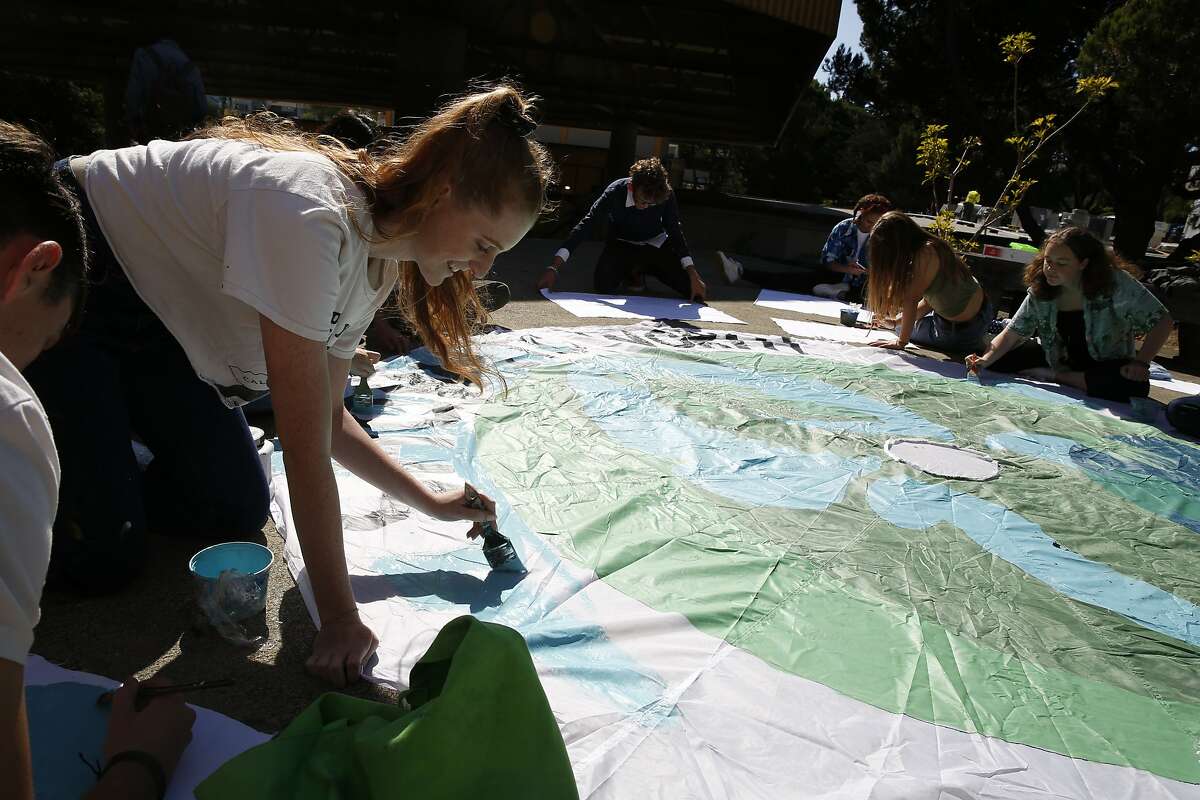 Grace McGee (left), co-president Asawa SOTA Environmental Club makes a sign for the Climate Strike with other club members and students at Ruth Asawa School of the Arts on Thursday, September 19, 2019 in San Francisco, CA.