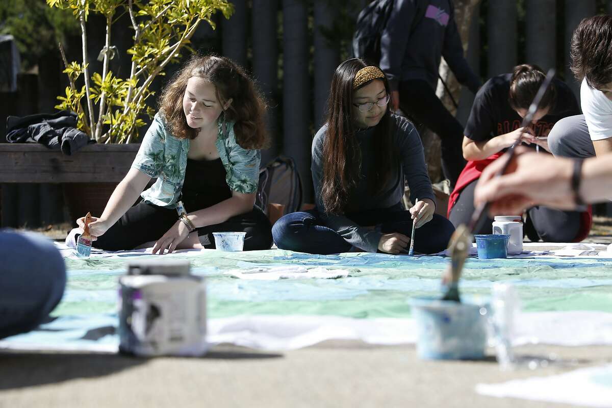 Nora McConnell (l to r), sophomore and Hannah Pon, senior; both Asawa SOTA Environmental Club members, work on painting signs for the Climate Strike with other club members and students at Ruth Asawa School of the Arts on Thursday, September 19, 2019 in San Francisco, CA.