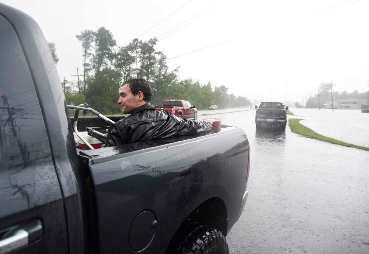 Levi Kelley sits in the back of a truck after getting rescued from his RV once water trapped him in it off of Aery Road in Vidor, Texas Thursday afternoon. Photo taken on Thursday, 09/19/19. Ryan Welch/The Enterprise