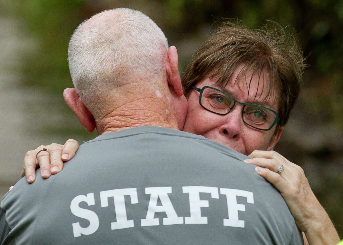 Jane Frazier embraces her husband, Mike, as he returns to his home in the Elm Grove subdivision after more than seven hours after leaving work in downtown Houston, Thursday, Sept. 19, 2019, in Kingwood. “We didn’t expect it to happen again,” Jane Frazier said after the family’s home flooded in May. “I mean, what are we going to do?”