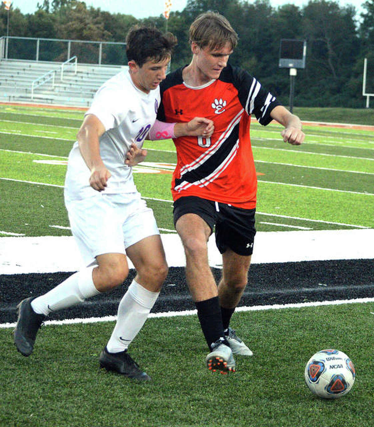 Edwardsville’s Alan Ebert, right, battles for the ball with a Collinsville player during the first half of Thursday’s game at the District 7 Sports Complex.