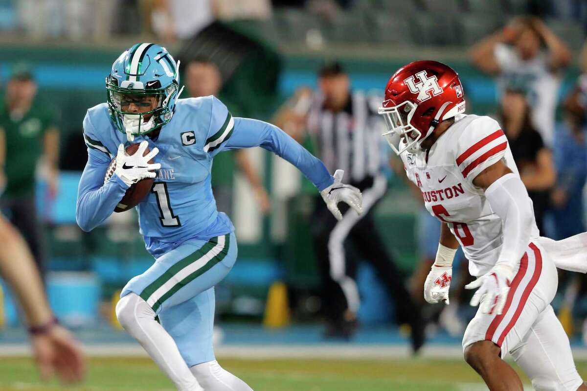 Tulane wide receiver Jalen McCleskey runs away from Houston cornerback Damarion Williams on the way to the winning touchdown during the final seconds Thursday.