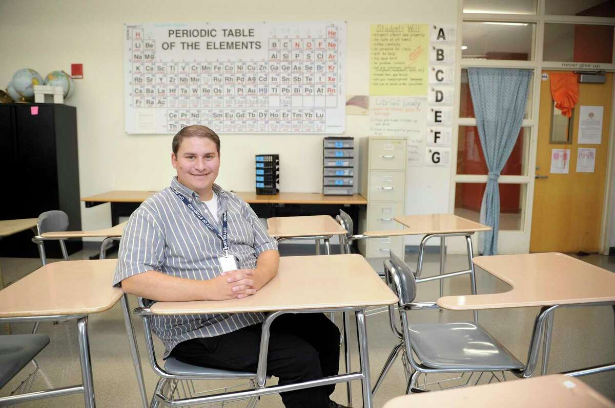 Eric Keller occupies the seat he sat in when he took science as a student at Stamford High School. Keller, who was photograph on Sept. 19, 2019, graduated from the school in 2011 and now teaches science at his alma mater.