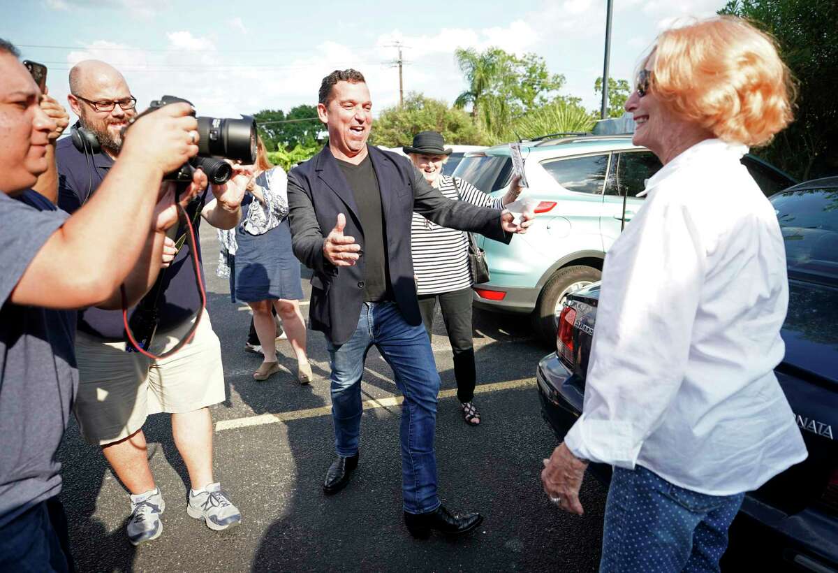 Tony Buzbee reacts after Kay Emberg, right, used his campaign sticker to cover over a Bill King For Mayor sticker already attached to her car bumper at a meet-and-greet event held at Molina's Cantina, 7901 Westheimer Rd., Sunday, Sept. 15, 2019, in Houston.