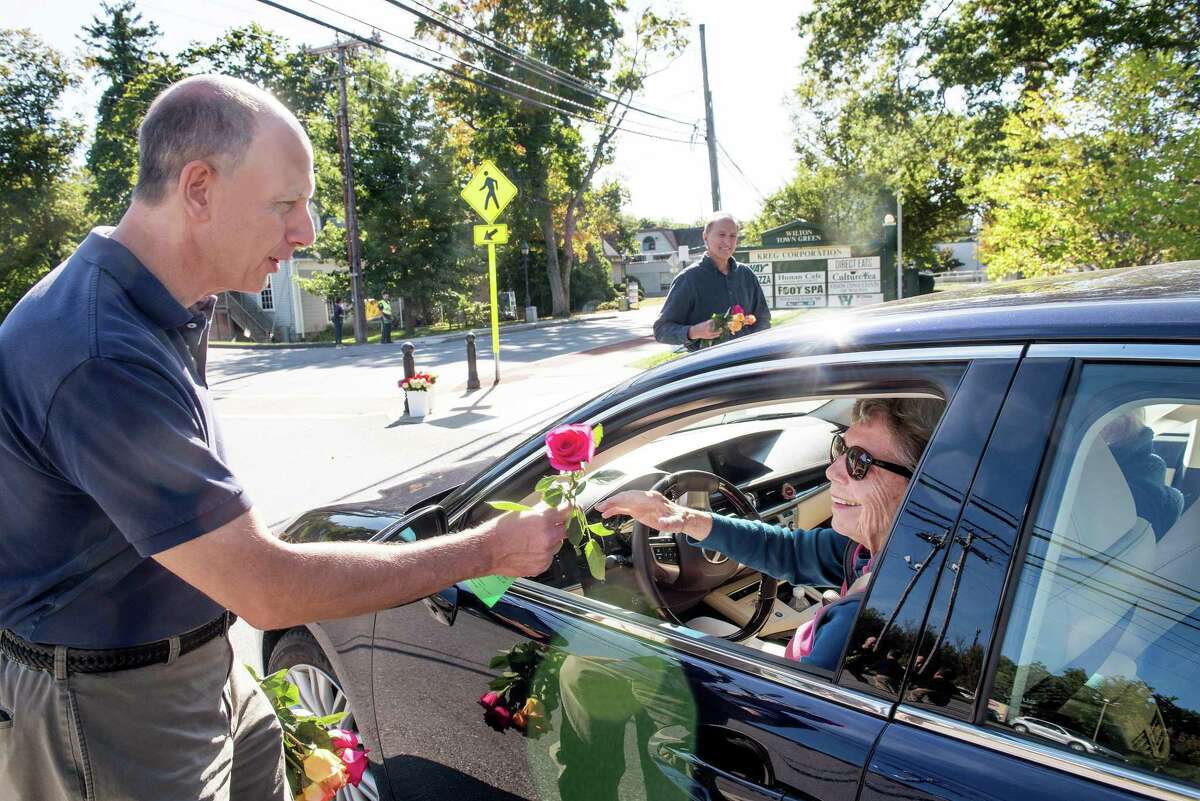John DiCenzo hands out a rose as part of the Wilton Chamber of Commerc’s Random Acts of Kindness day on Friday, Sept. 20.