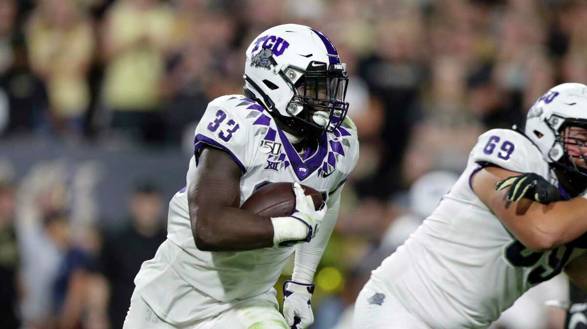 TCU running back Sewo Olonilua (33) runs against Purdue during the second half of an NCAA college football game in West Lafayette, Ind., Saturday, Sept. 14, 2019. (AP Photo/Michael Conroy)