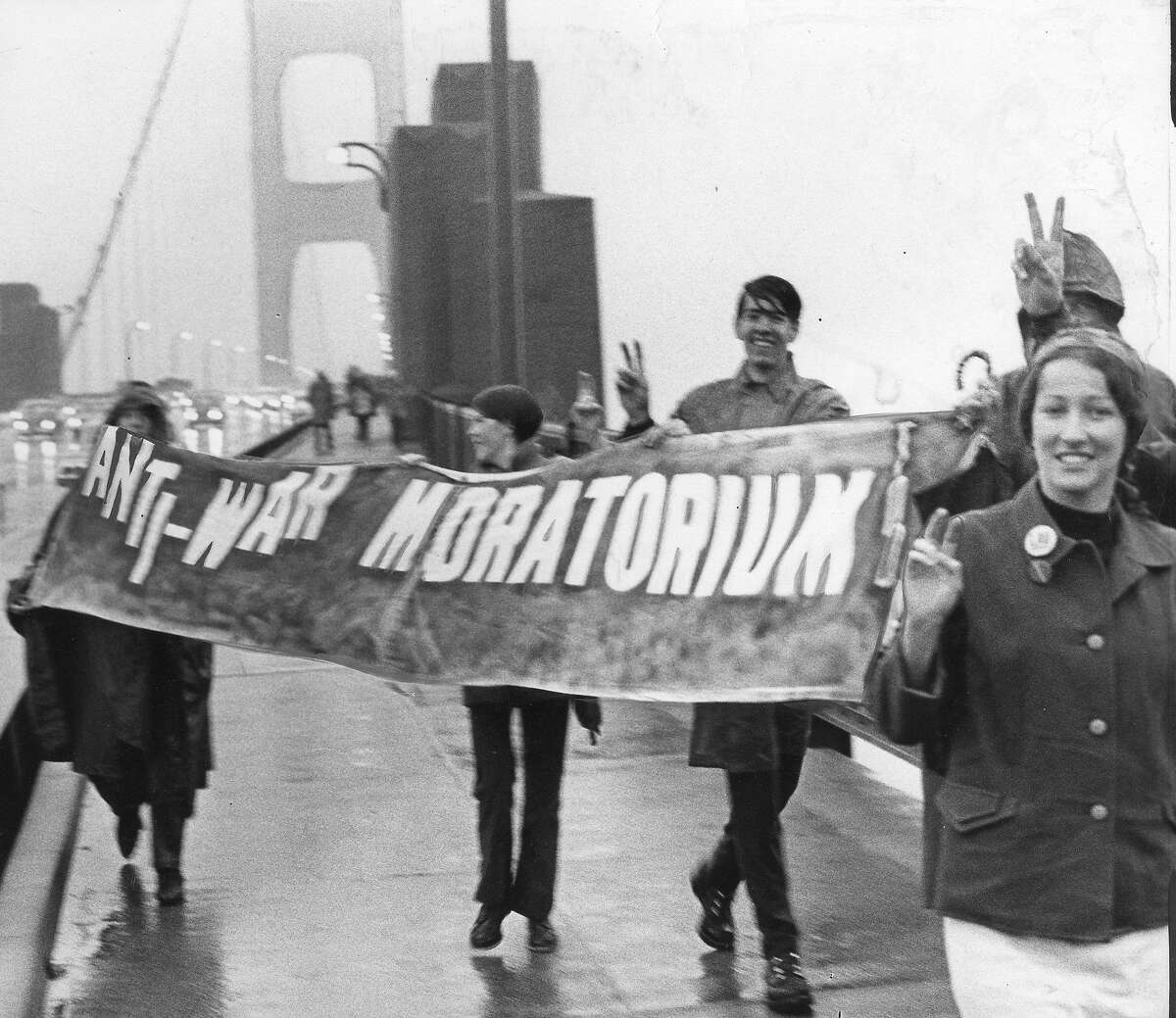 Anti war protestors carry signs as they march across the Golden Gate Bridge on Moratorium Day, October 15, 1969 Photo ran 10/16/1969, p. 6