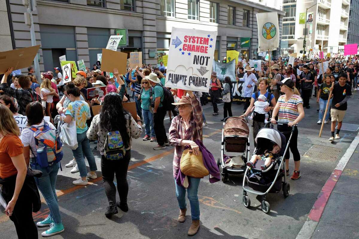 People march through the Financial District in a climate strike Friday, Sept. 20, 2019, in San Francisco. A wave of climate change protests swept across the globe Friday, with hundreds of thousands of young people sending a message to leaders headed for a U.N. summit: The warming world can't wait for action.