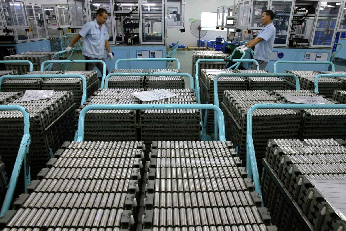 FILE - In this July 27, 2018, file photo, workers transfer Lithium-ion batteries in a factory in Taizhou in east China's Jiangsu province. The U.S. government is leading an ambitious effort to develop ways to recycle lithium-ion batteries from electric vehicles, cellphones and other sources to ensure a reliable and affordable supply of metals crucial to battery production. Officials say it is an attempt to catch up with China and other countries that manufacture and recycle the vast majority of lithium-ion batteries, including those shipped back from the U.S. (Chinatopix via AP, File)