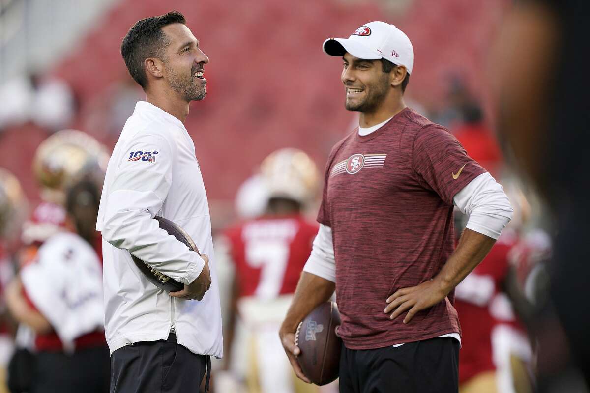 San Francisco 49ers coach Kyle Shanahan, left, had a voice in giving Jommy Garoppolo what was for a brief time the richest contract in NFL history. Now he has to consider just how long the team should hold on to Garoppolo before sending him elsewhere.