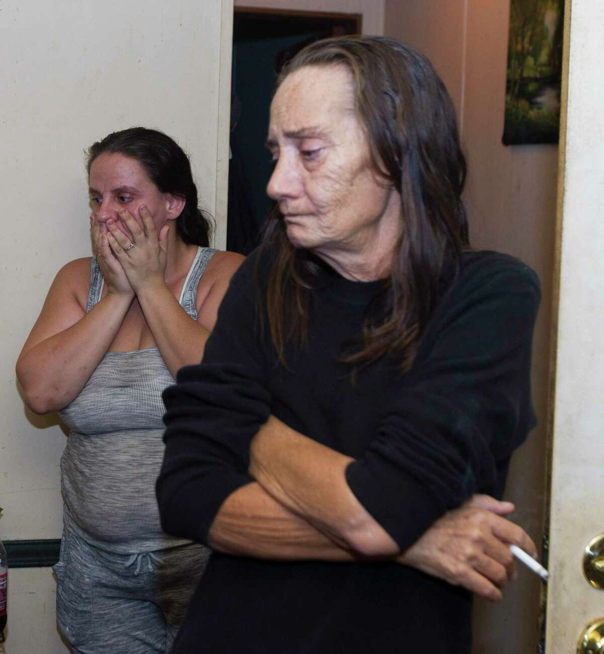 Tamatha Lee, left, reacts beside her father’s fiancé, Margret Cameron, to seeing their home for the first time after Tropical Depression Imelda flooded their property with five and a half feet of water, Friday, Sept. 20, 2019, in Splendora.