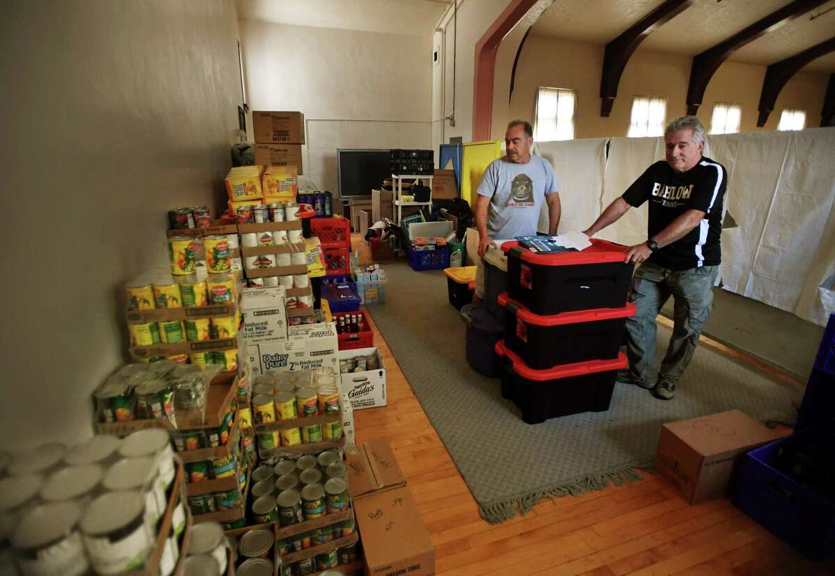 Volunteers Mark Silverman, left, of Danbury, and James Fleming, of Redding, in the Daily Bread Food Pantry's temporary food storage area at St. James Episcopal Church at 25 West Street in Danbury, Conn. on Wednesday, September 18, 2019. The food pantry is reconfiguring their space with an $85 thousand grant received from HUD.