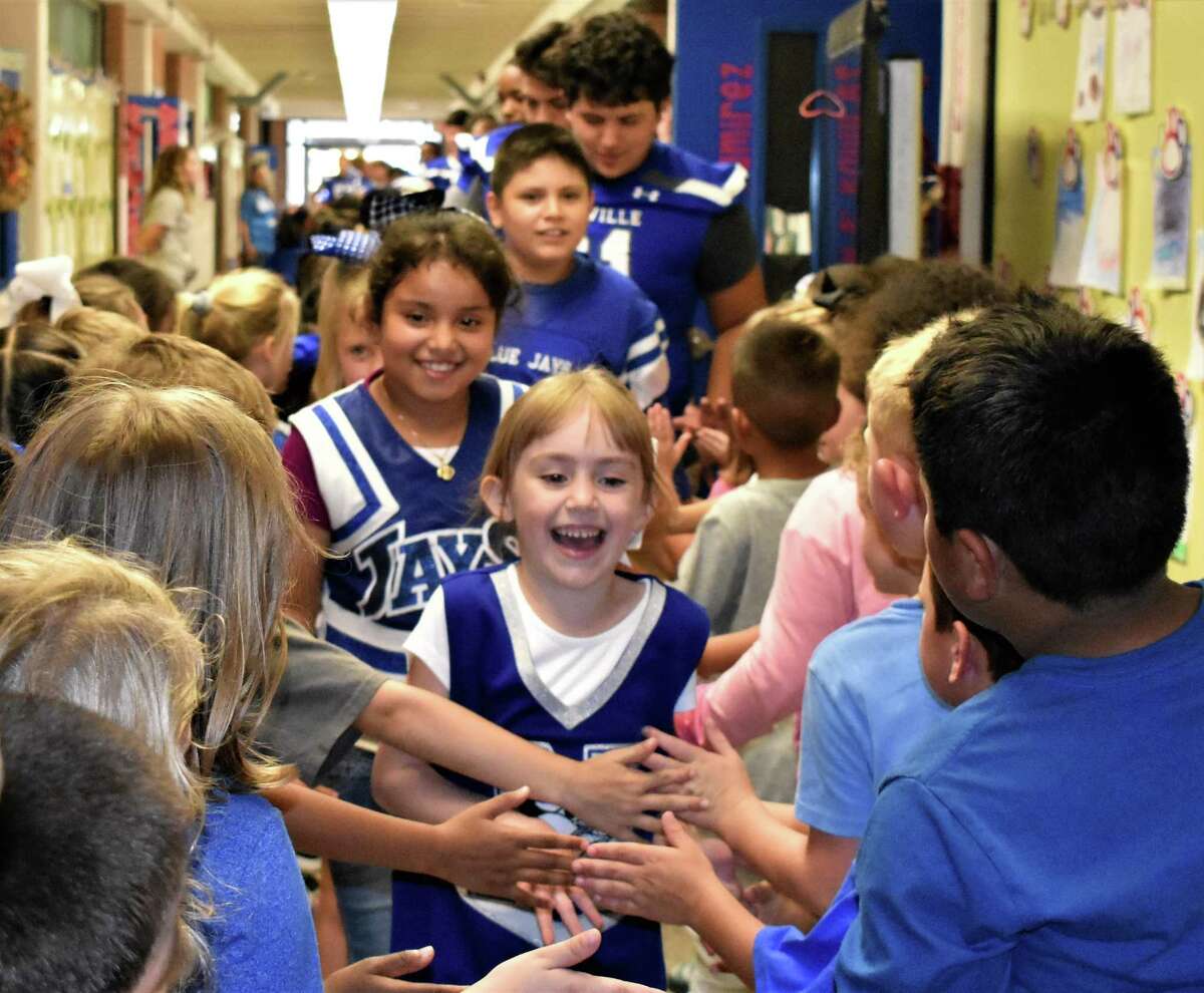 Needville football players make way through elementary school