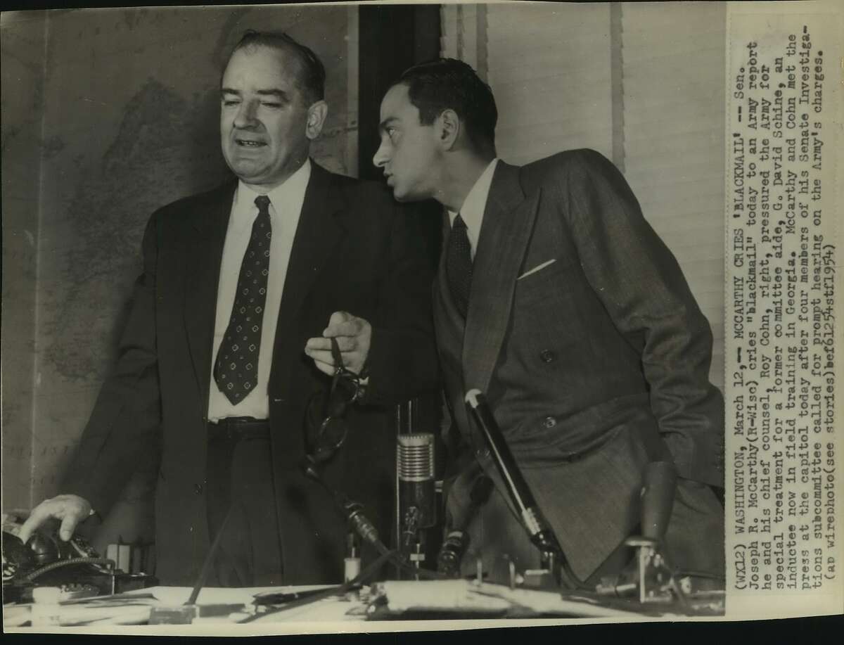Senator Joseph R. McCarthy, Republican of Wisconsin cries "Blackmail" today to an Army report he and his chief counsel, Roy Cohn, right, pressured the Army for special treatment for a former committee aide, G. David Schine, an inductee now in field training in Georgia. 
