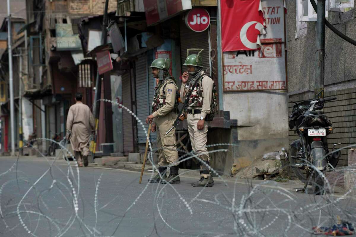 Indian paramilitary soldiers stand guard during restriction in downtown Srinagar, Indian controlled Kashmir, Friday, Sept. 20, 2019. Life remained crippled as schools, shops and business establishment remained closed due to strike since Aug. 5, after the Indian government revoked the special status of Indian controlled Kashmir.
