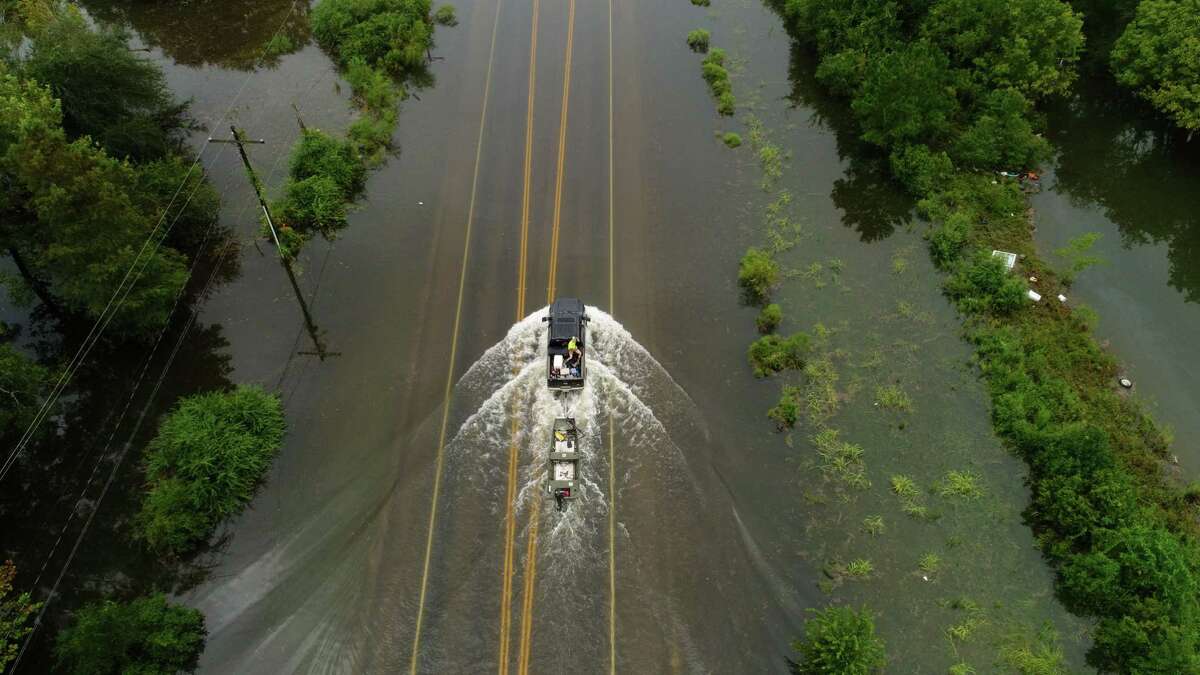 A rescue crew travels through flood waters from Tropical Storm Imelda on Texas 124 in Fannett on Friday. Photo taken Friday, 9/20/19