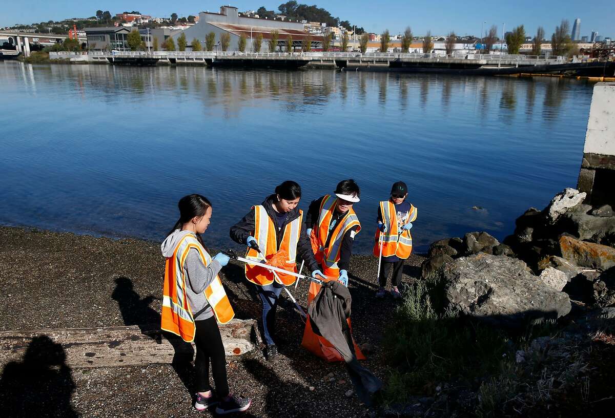 Volunteers pick up trash and debris along Islais Creek in San Francisco, Calif. on Saturday, Sept. 21, 2019. More than 3,500 volunteers pre-registered to participate in the city for the Battle For The Bay 2019 competition on Coastal Cleanup Day pitting San Francisco against Oakland and San Jose.