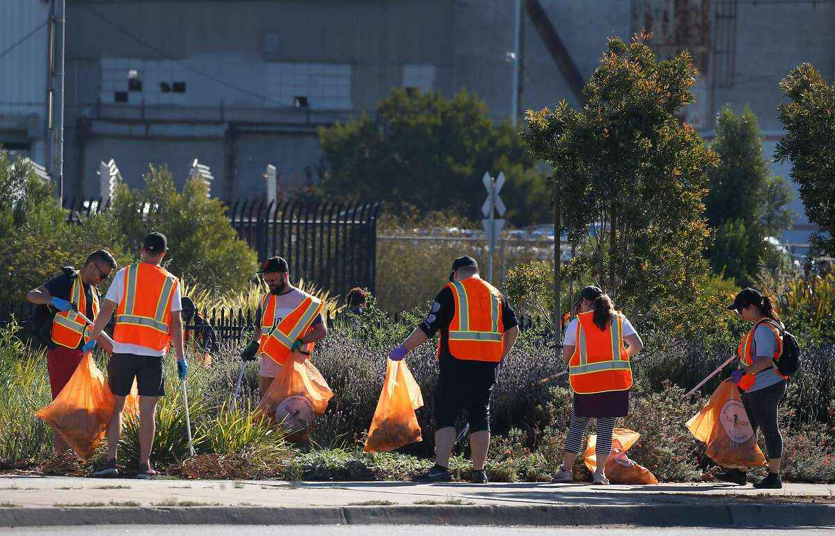Volunteers pick up trash and debris near Islais Creek in San Francisco, Calif. on Saturday, Sept. 21, 2019. More than 3,500 volunteers pre-registered to participate in the city for the Battle For The Bay 2019 competition on Coastal Cleanup Day pitting San Francisco against Oakland and San Jose.