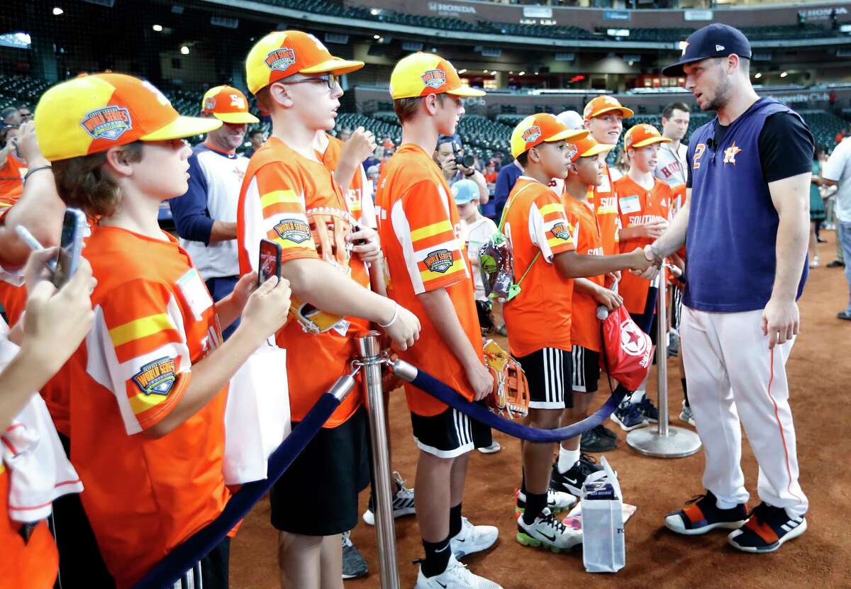 Houston Astros Alex Bregman greets members of the Eastbank Little League from New Orleans, who recently won the Little League World Series during batting practice before the start of an MLB baseball game at Minute Maid Park, Saturday, Sept. 21, 2019, in Houston.