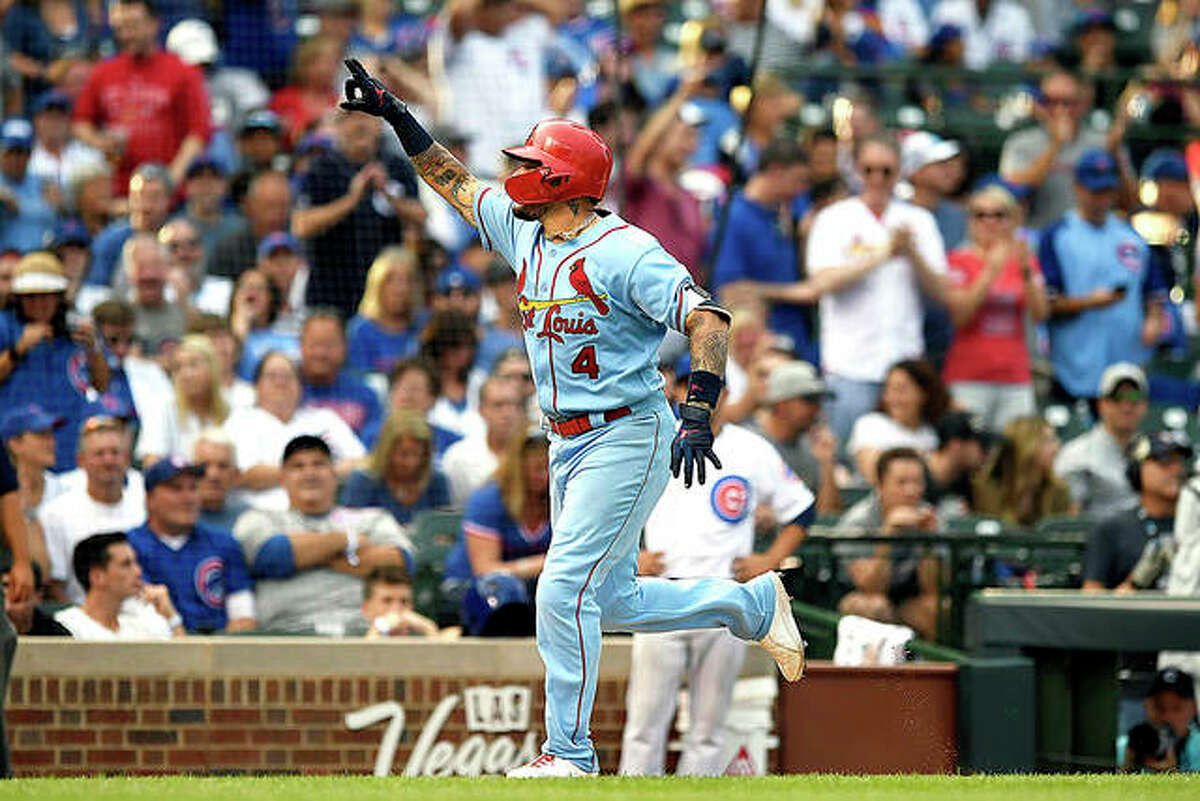 The Cardinals’ Yadier Molina celebrates while rounding the bases after hitting a solo home run in the ninth inning of Saturday’s win over the Cubs in Chicago.